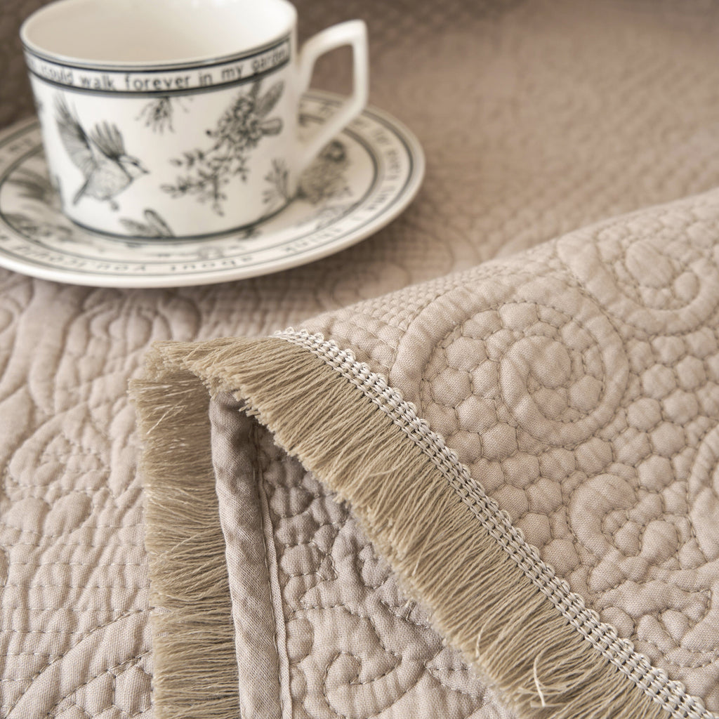 DaDa Bedding Elegant Fringed Cotton Quilted Throw Blanket - Luxurious Solid Soft Paisley Pattern, Cozy Lightweight Lap Throw, Perfect for Couch or Bed, Neutral Sandy Taupe Tan Beige, 50x60 Inches